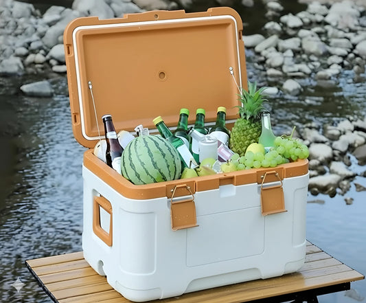 Open 50L insulated cooler box filled with drinks and food, sitting on a wooden table outdoors 144-5