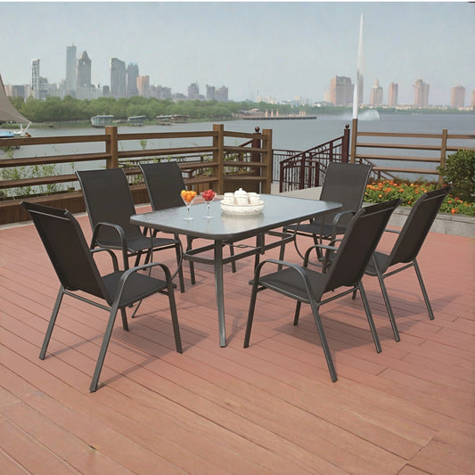Outdoor dining set on a wooden deck with a city skyline in the background