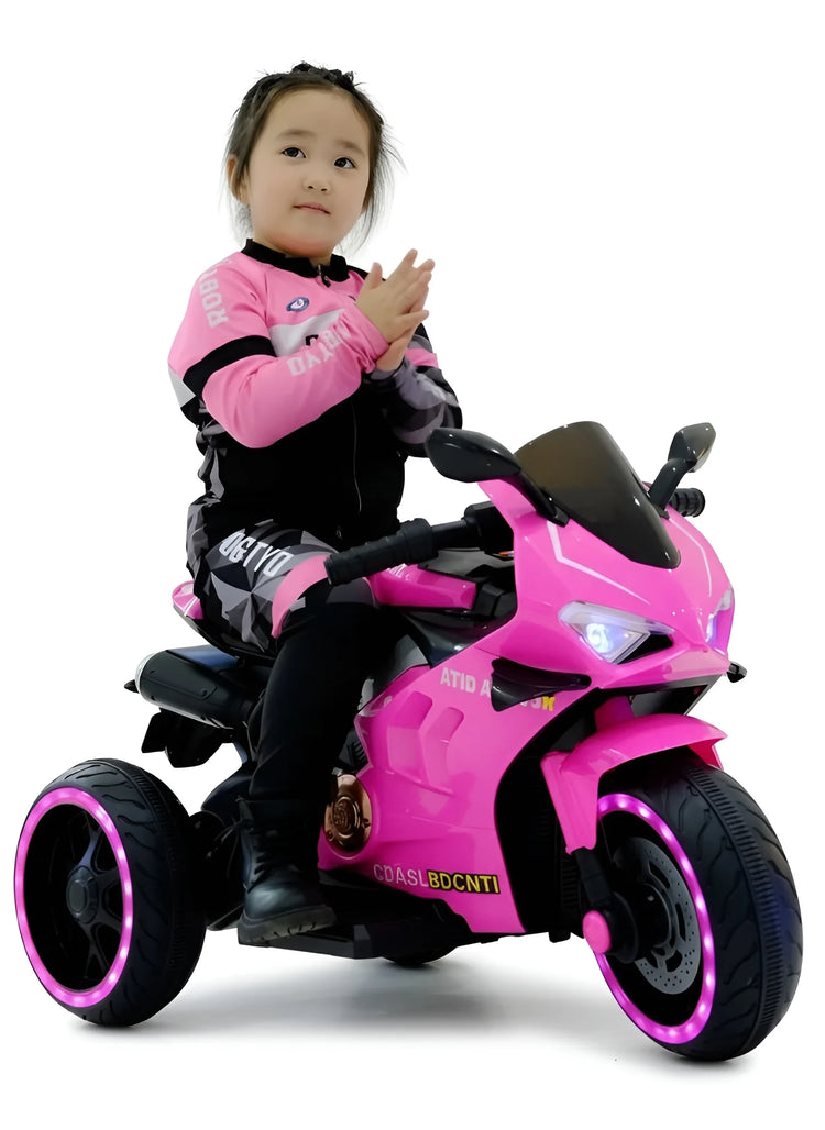 Young girl on a pink kids' ride-on motorcycle trike with glowing wheels Y-MB7105