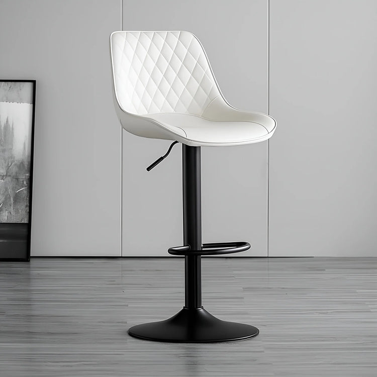 White quilted chair with black base on a gray floor and wall background