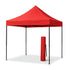 Front view of a portable 2x2 meter steel frame red gazebo, shown with its carrying bag.