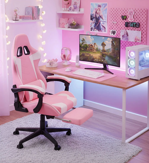 Pink gaming chair in a room with a desk, computer setup, and decorative elements.