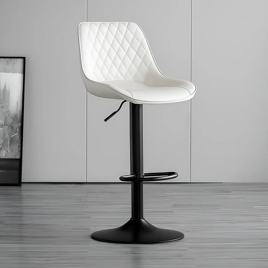White quilted chair with black base on a gray floor and wall background