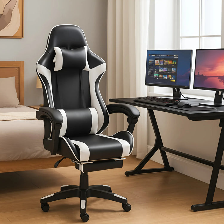 Black and white gaming chair in a room with a desk and computer monitors.